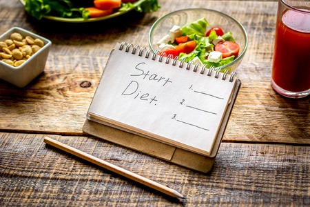 concept diet and slimming plan with vegetables close up on wooden backgroundの写真素材