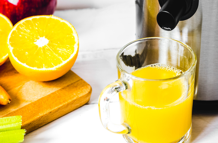 process of preparation of fresh juice in juicer close upの写真素材