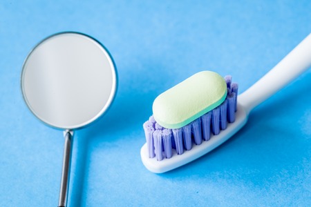 concept tooth pain - dentist tools, tablet at blue backgroundの写真素材
