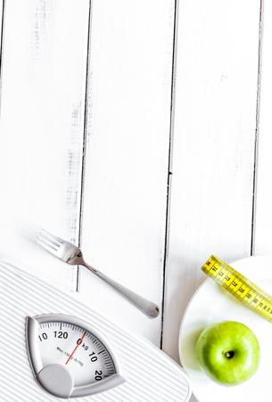 floor scale and apple on wooden background top viewの写真素材
