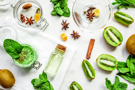 woman cosmetic set with kiwi scrub table background top viewの写真素材