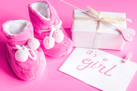 babys bootees and gift box on wooden backgroundの写真素材