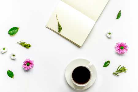 Notebook with cup of coffee on white  top view mockupの写真素材