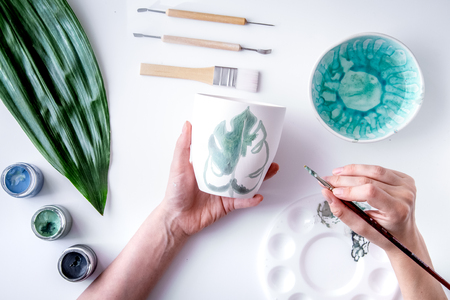 painted ceramic cup on white background top viewの写真素材