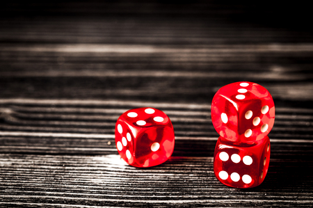 concept luck - dice gambling on dark wooden backgroundの写真素材