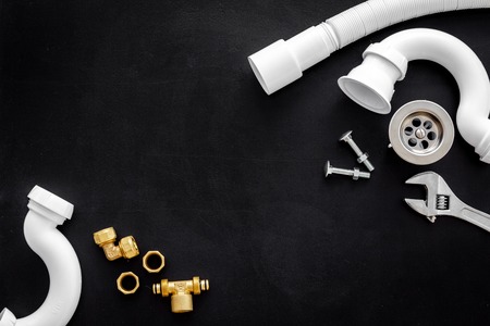 Plumber profession with gear and instruments for repair tubes on black background top view copyspaceの写真素材