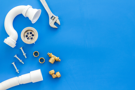 Plumber work with instruments, tools and gear on blue background top view mockupの写真素材