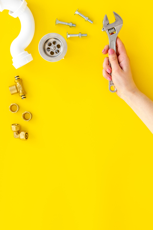 Plumber work with instruments, tools and gear on yellow background top viewの写真素材