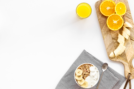 food for healthy breakfast with granola and fresh orange juice on bright white background top view mock upの写真素材