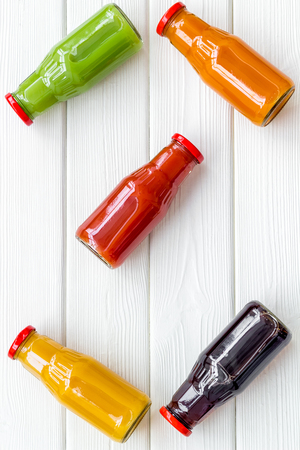 fresh organic juices in bottles for fitness diet on white wooden background top view mock-upの写真素材