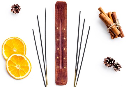 air freshener sticks with cinnamon and orange on white background top viewの写真素材