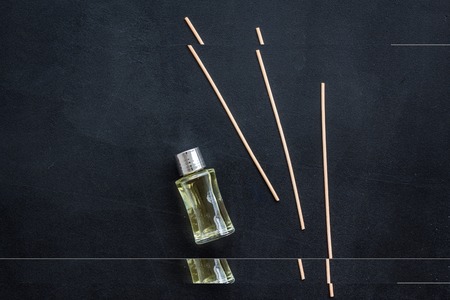 floral fragrance diffuser for air freshness on dark background top view mock-up
