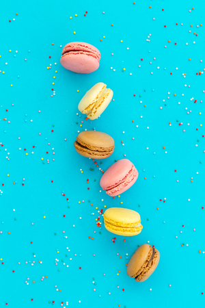 Macarons design on blue background top view space for textの写真素材