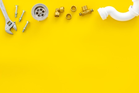 Plumber profession with gear and instruments for repair tubes on yellow background top view copyspaceの写真素材