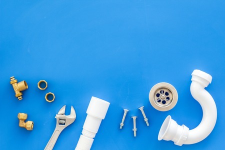 Plumber work with instruments, tools and gear on blue background top view mockupの写真素材