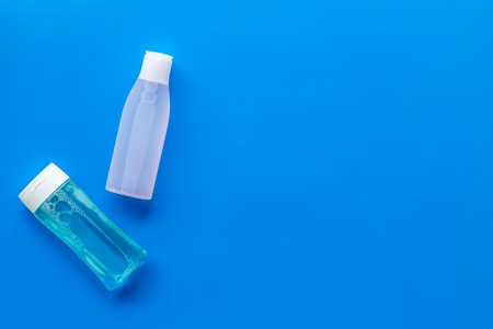 Organic cosmetics for face clearing with facial tonic and mycelial water on blue background top view...