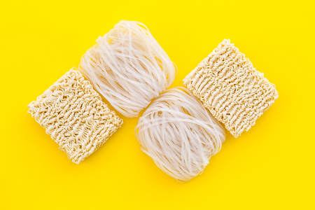 Rice vermicelli, noodles to cook Chinese and Japanese food design on yellow background top view copy...