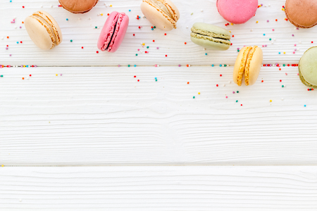 Macarons design on white wooden background top view space for textの写真素材
