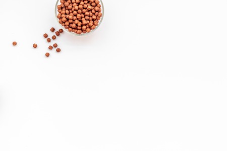 Healthy breakfast. Chocolate balls, corn cereals in bowls on white background top view space for textの写真素材