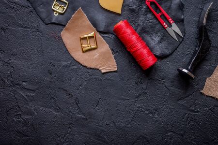 leather craft instruments on dark background top view mock upの写真素材
