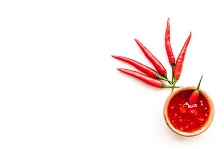 Cooking hot food with chilli pepper on white table background top view copy space