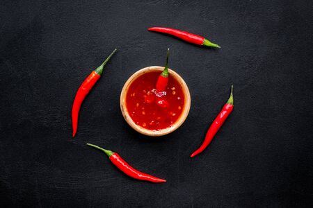 Fresh red chilli pepper as food ingredient on dark table background top viewの写真素材