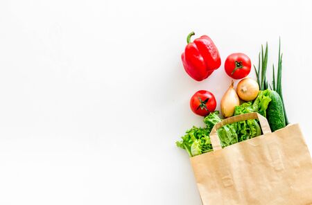 Buying fresh vegetables in paper bag on white background top view copyspaceの写真素材