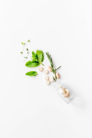 Alternative medicine. Store up medicinal herbs and pills on white background top view space for textの写真素材