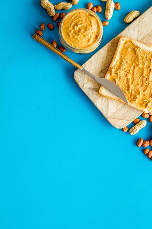 peanut butter for cooking breakfast with sandwiches at home on blue background top view mock-up