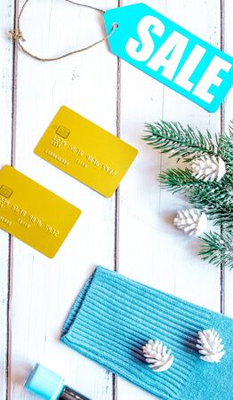 winter clothing sale on wooden background top view.の写真素材