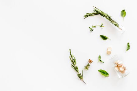 Alternative medicine with medicinal herbs and pills on white background top view mock upの写真素材