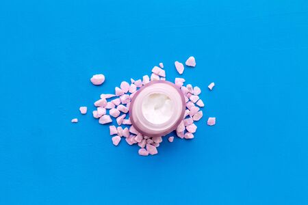 Cosmetics with sea salt decoration on blue background top viewの写真素材