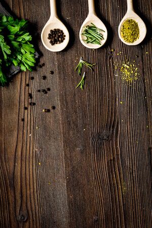 spices and fresh salad on dark wooden table top viewの写真素材