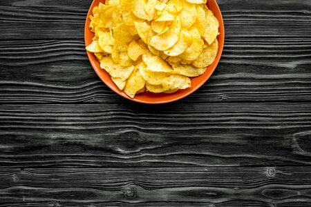 Potato crisps on wooden background top view mockupの写真素材