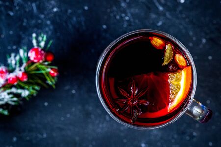 Christmas mulled wine with spices in cup on dark backgroundの写真素材