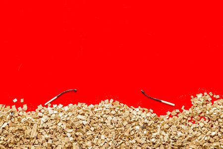 Fire concept with kindling frame and burnt matches on red background top view mock up