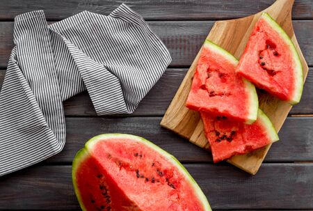 Cut watermelon for break with fruit on wooden background top viewの写真素材
