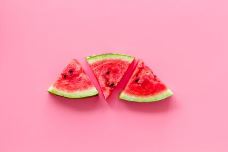 Summer fruit. Slices of watermelon on pink background top view