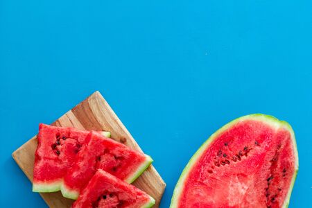Slices of watermelon on blue background top view mock upの写真素材