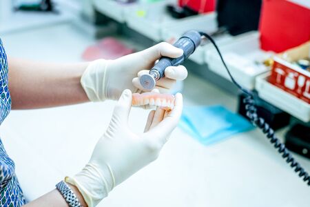 Dental technician working the partial denture. Modern dental office