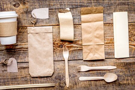 food delivery service workdesk with paper bags and plastic cup on restourant wooden table background...