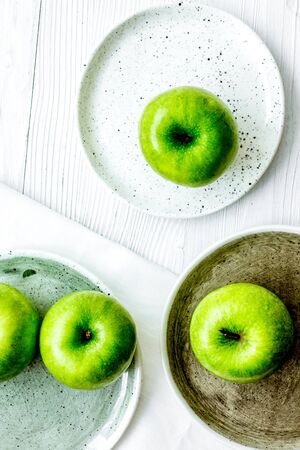 Healthy green food with apples on plates white background top viewの写真素材