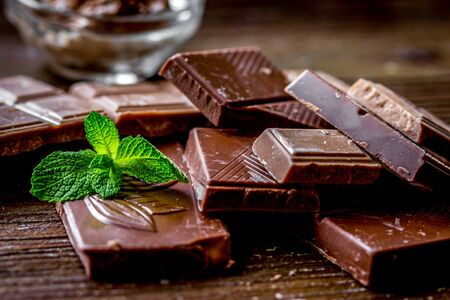 chocolate pieces with mint on wooden table backgroundの写真素材