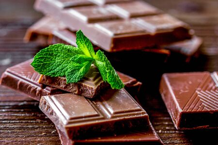 black and milk chocolate bars on dark wooden table backgroundの写真素材