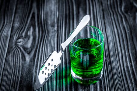 absinthe with sugar cubes and spoon on wooden backgroundの写真素材