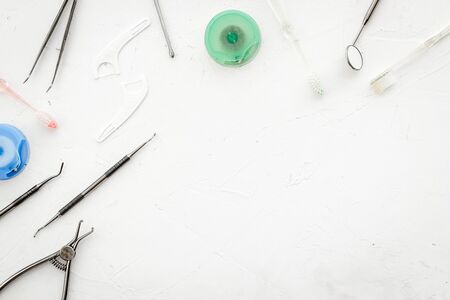 Dental care concept. Stomatological tools frame - with floss - on white background top-down.の写真素材