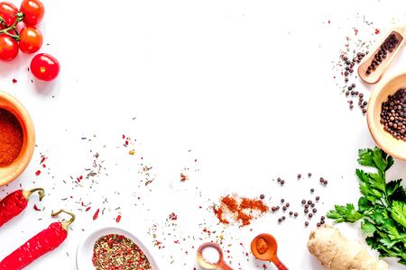 spices in wooden spoon on white background top view.の写真素材