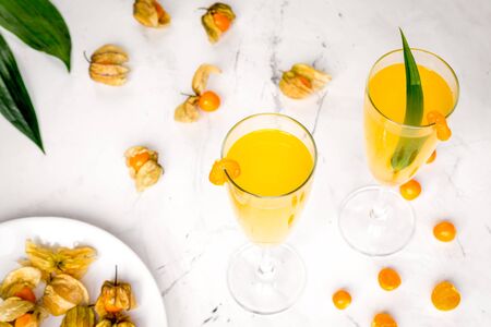 cocktail with physalis in glass on stone background close upの写真素材
