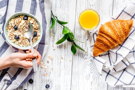 Breakfast concept with flowers on wooden background top viewの写真素材