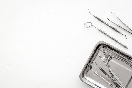 Stomatological tools in tray on dentists desk on whiteの写真素材